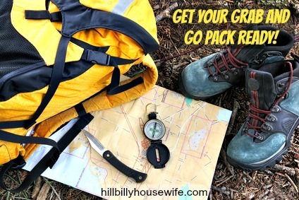 Hiking shoes on map with compass and backpack