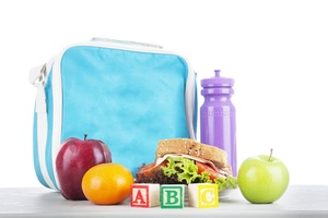 Blue lunch box, purple water bottle a sandwich and fruit