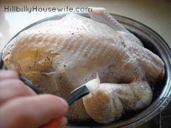 Brushing the turkey with melted, seasoned butter. 