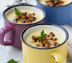 Mugs of homemade cream of mushroom and potato soups