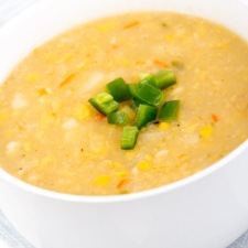 A bowl of homemade corn chowder with simple garnish.