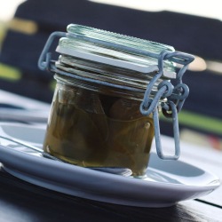 A small glass jar with candied jalapenos a.k.a cowboy candy